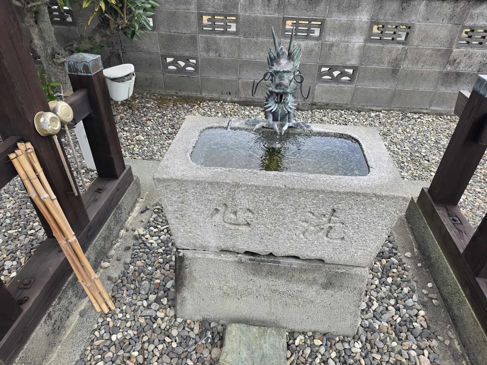 龍の水口を備えた石造の手水鉢。