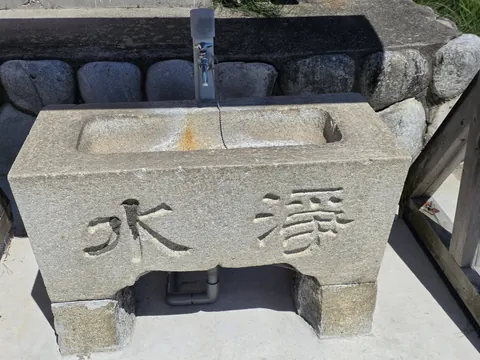 「浄水」と刻まれた石造の手水鉢。
