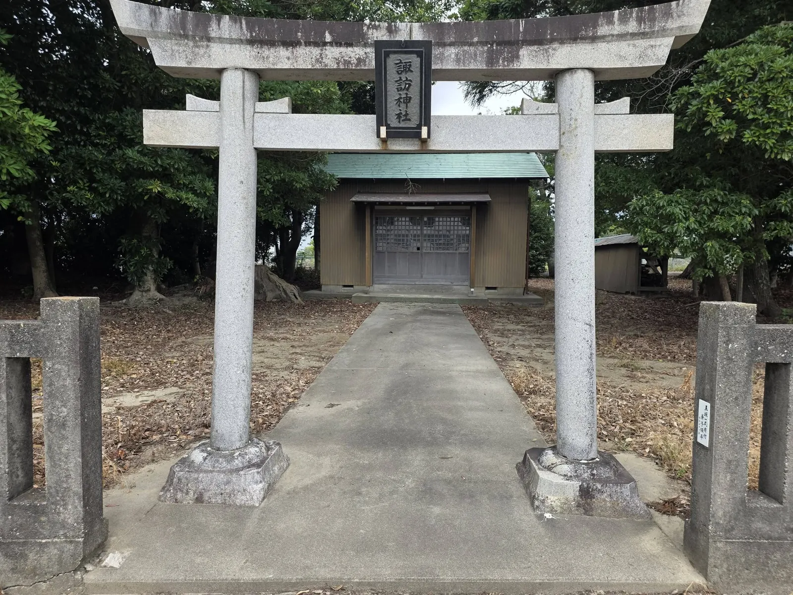 石造鳥居の正面から諏訪神社の社殿を望む。