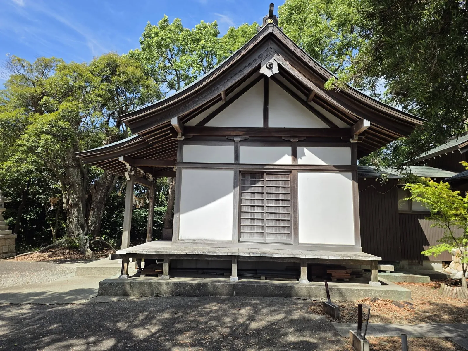 参道側から見た社殿正面。入母屋造の大きな屋根と白壁の外観。