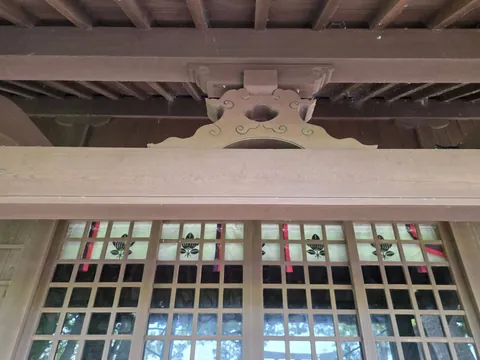 社殿正面の木組みと格子戸の意匠。